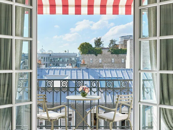 An open balcony with a view of buildings and a blue-roofed structure.