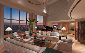 A spacious living room with a grand piano, comfortable seating, and large windows offering a city view.