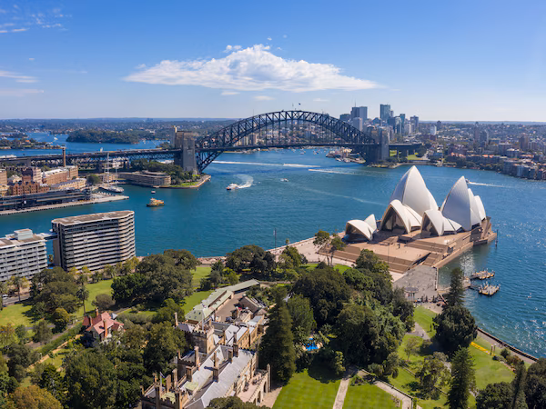 The Sydney Opera House, Sydney Harbour Bridge, and surrounding cityscape.